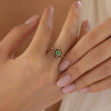 Emerald and yellow gold granulated ring on hand