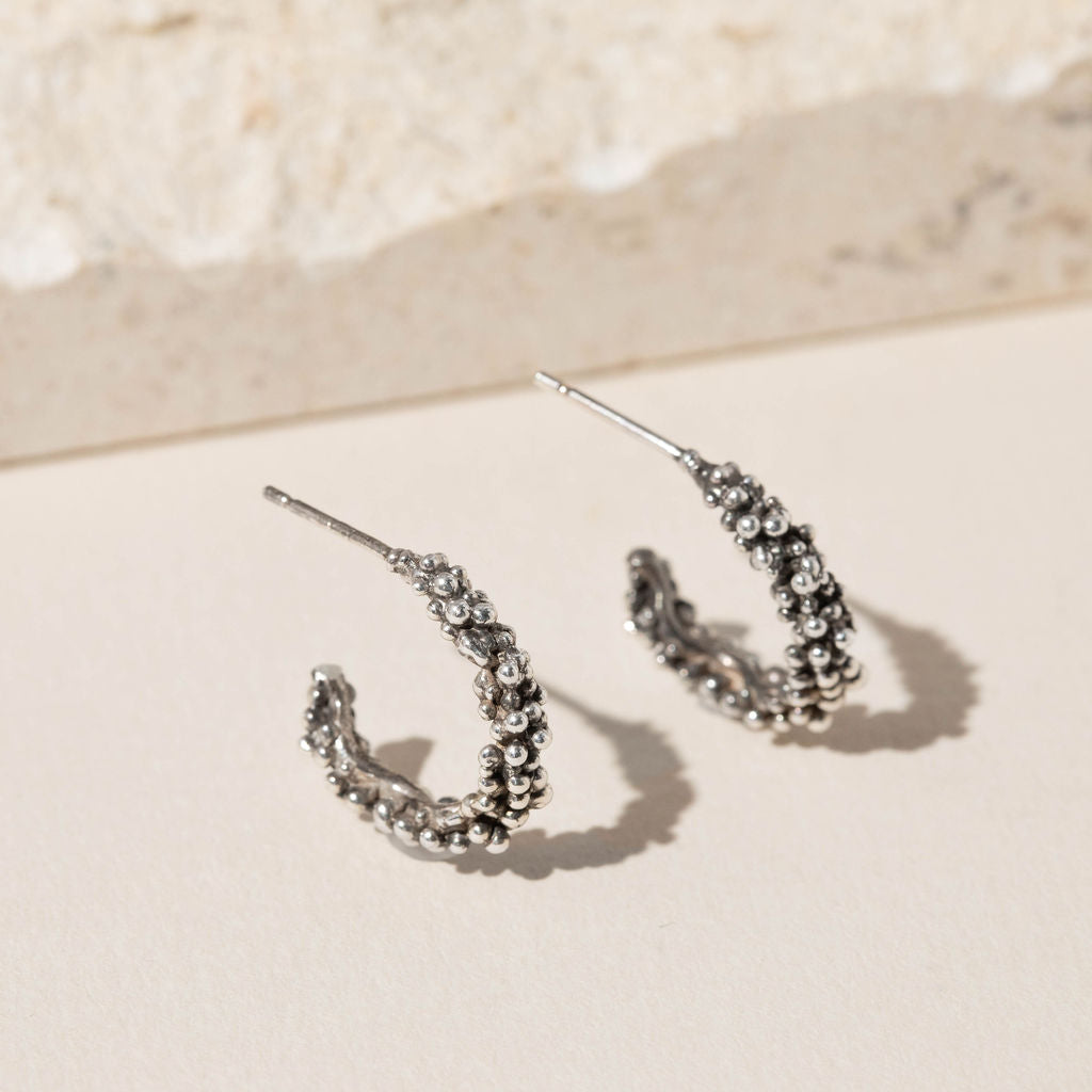 Oxidised Sterling silver bubble hoop earrings with organic molten texture, artisan made jewellery in the UK