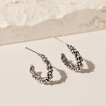 Oxidised Sterling silver bubble hoop earrings with organic molten texture, artisan made jewellery in the UK