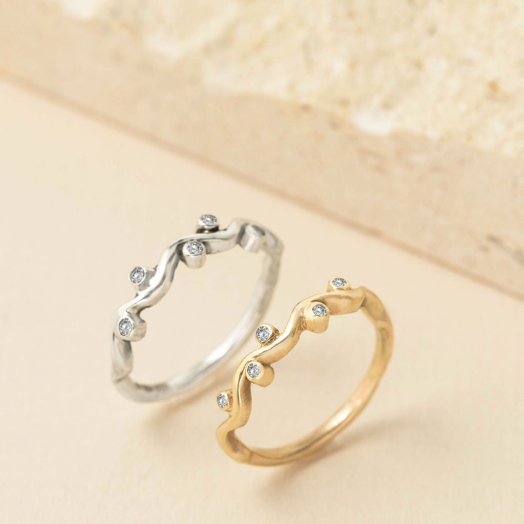 Gold and silver ocean wave rings with sparkling diamond accents, handcrafted by Rockpool Jewellery in an organic, flowing coastal-inspired design