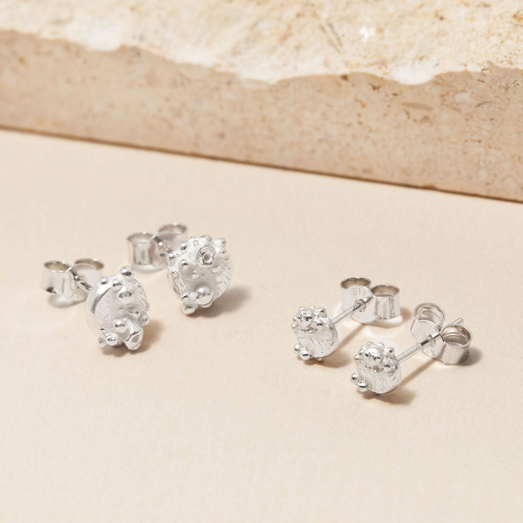 Sterling silver barnacle stud earrings shown in different sizes, with ocean-inspired handcrafted detail by Rockpool Jewellery