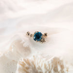 Blue stone ring on cream linen fabric