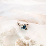 Blue stone ring on white fabric background