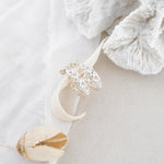Silver hoops with white cloth and white coral in background