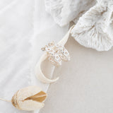 Silver hoops with white cloth and white coral in background