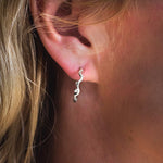 Sterling silver wave-inspired hoop earring with ocean diamonds worn on ear, handcrafted by Rockpool Jewellery with flowing oceanic curves and organic coastal design